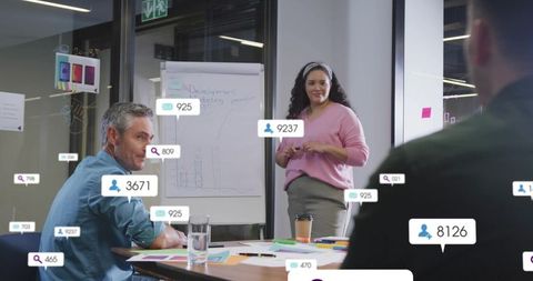 Female leader presenting business metrics in boardroom for collaborative strategy meeting