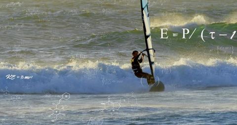 Windsurfer riding waves with mathematical equations overlay at sunrise