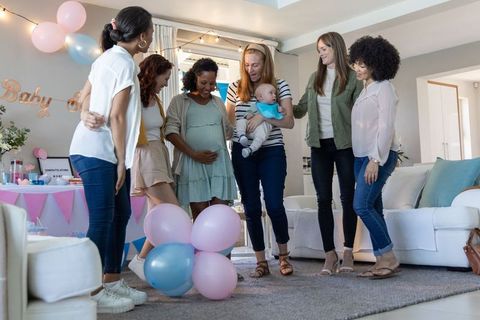 Diverse Friendship Celebrating Baby Shower in Cozy Living Room