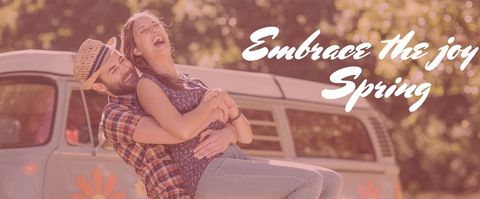 Joyful Couple Embracing in Front of Vintage Van During Spring