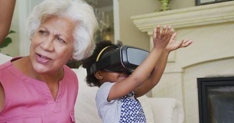 Grandmother with Child Exploring Virtual Reality at Home