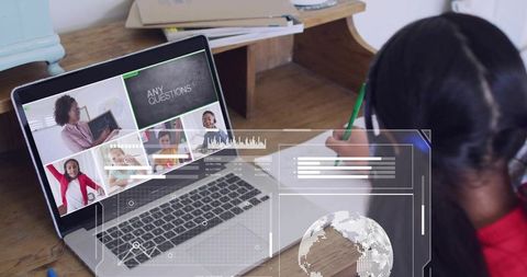Schoolgirl Writing During Virtual Lesson Wearing Headset at Home Desk with Laptop