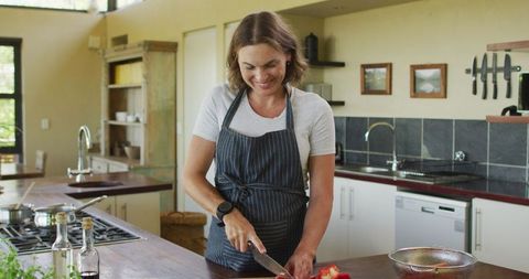 Pregnant Woman in Apron Cutting Vegetables Preparing Meal