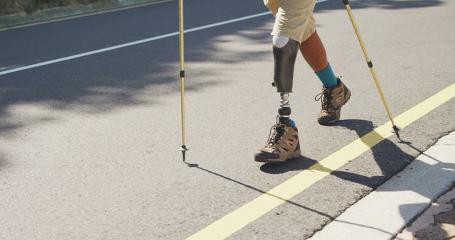 Person with Prosthetic Leg Hiking on Road with Trekking Poles - Download Free Stock Images Pikwizard.com