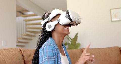Joyful woman with vr headset experiencing virtual moments