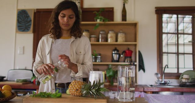 Woman Preparing Refreshing Beverage in Cozy Kitchen - Download Free Stock Images Pikwizard.com