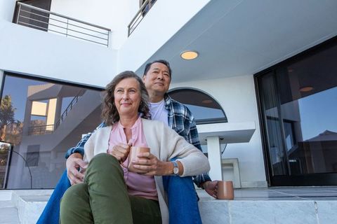 Senior Couple Enjoying Peaceful Moment on Modern Balcony