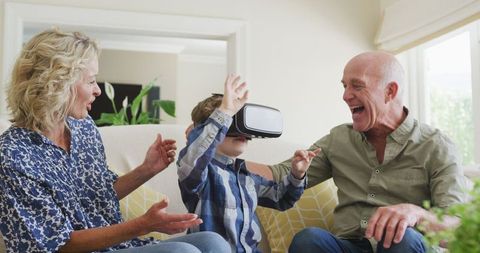 Grandparents Enjoying Virtual Reality Experience with Grandson