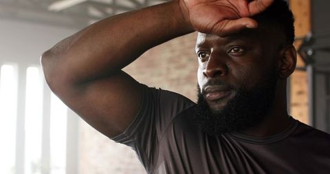 Focused Athlete Resting During Intense Gym Workout