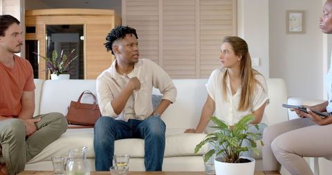 Diverse group discussing project in modern living room