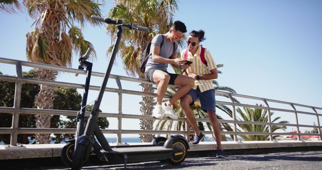 Friends with Electric Scooter Enjoying Sunny Day by Beach - Download Free Stock Images Pikwizard.com