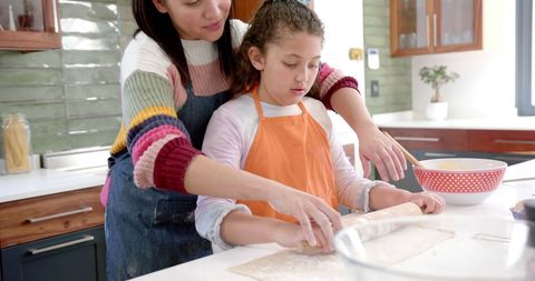 Happy Mother and Daughter Baking Together in Bright Sunny Kitchen