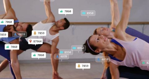 Group practicing side-bend yoga with social media notification overlays in fitness studio