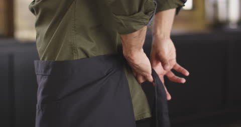 Chef Preparing for Work in Professional Kitchen
