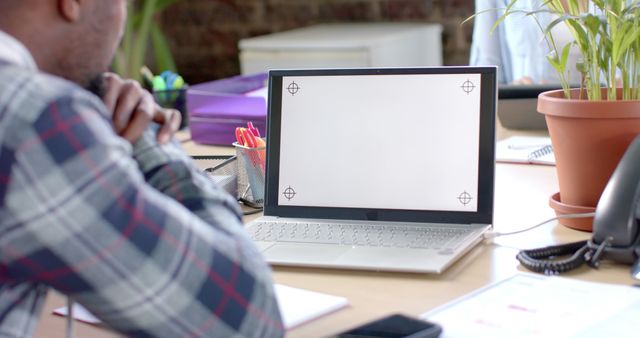 Man Working at Desk with Blank Laptop Screen in Office Setting - Download Free Stock Images Pikwizard.com