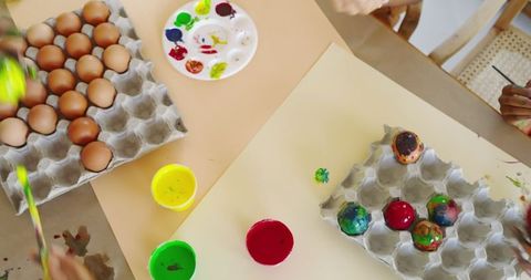 Family Decorating Eggs Together for Festive Celebration Crafting
