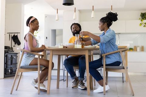 African american family enjoying breakfast in modern open-plan kitchen