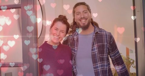 Happy Couple at Home Surrounded by Floating Hearts