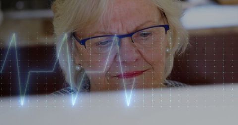 Senior Woman with Cardiograph Laptop Interface Technology