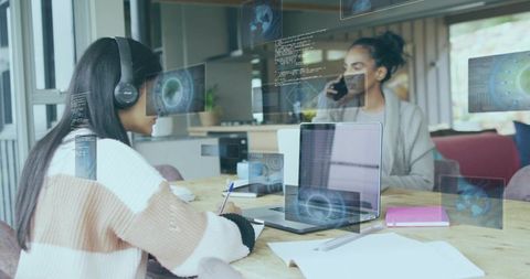 Teen Collaborating with Mentor on Coding Project Using Laptop and Smartphone with Digital Code Overl