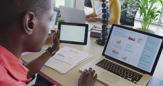 Businessman Analyzing Financial Data on Laptop and Tablet - Download Free Stock Images Pikwizard.com