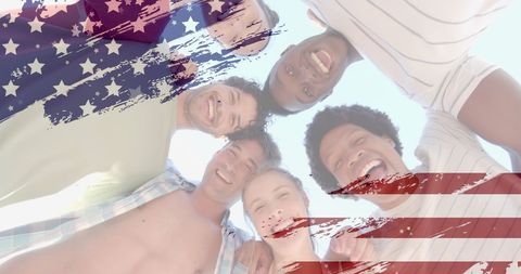 Diverse Friends Holding American Flag on Sunny Beach