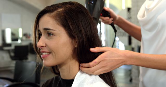 Woman with Towel Enjoying Hair Dryer in Salon - Download Free Stock Images Pikwizard.com