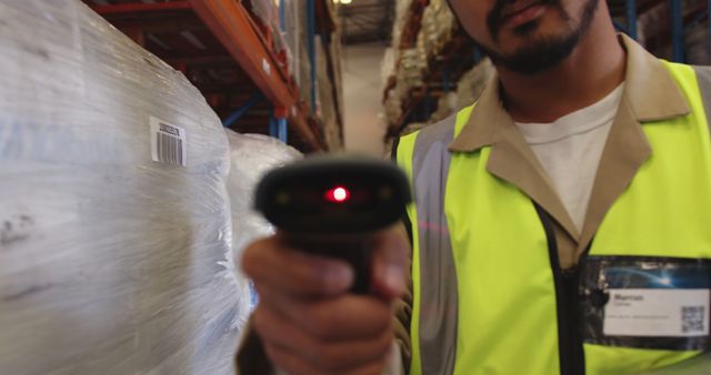 Asian male warehouse worker using barcode reader in warehouse. Business, work, shipping, storage, technology and industry, unaltered.