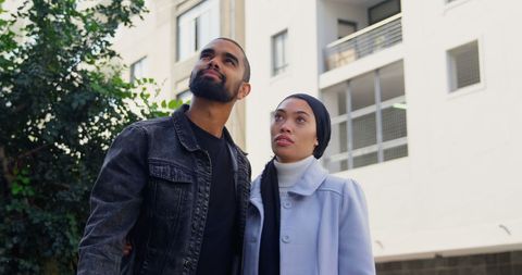Contemplative couple observing urban landscape