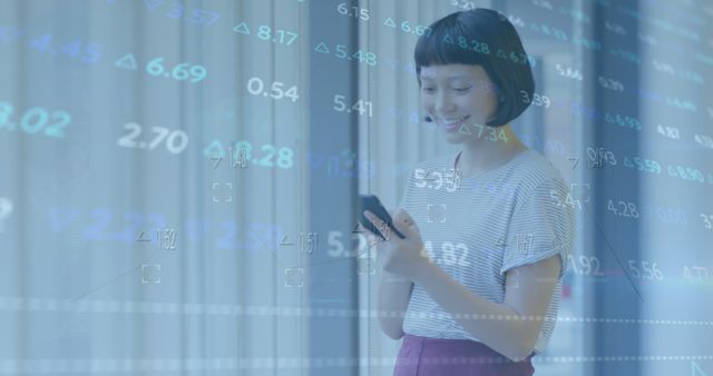 Image of stock market data processing against happy asian woman using smartphone at office. Global economy and business technology concept