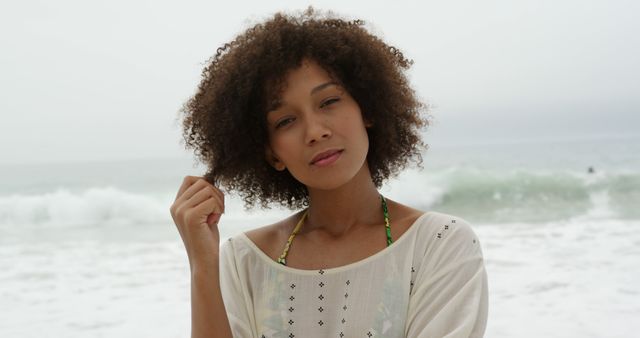 Young Woman at Beach Holding Hair in Natural Candid Moment - Download Free Stock Images Pikwizard.com