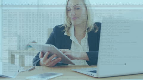 Businesswoman Analyzing Data on Tablet in Office