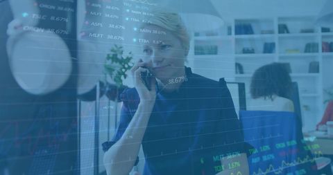 Businesswoman Analyzing Financial Data While on Phone