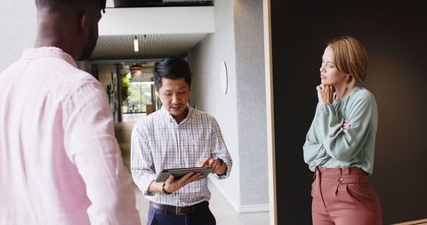 Business Colleagues Discussing Ideas with Digital Tablet