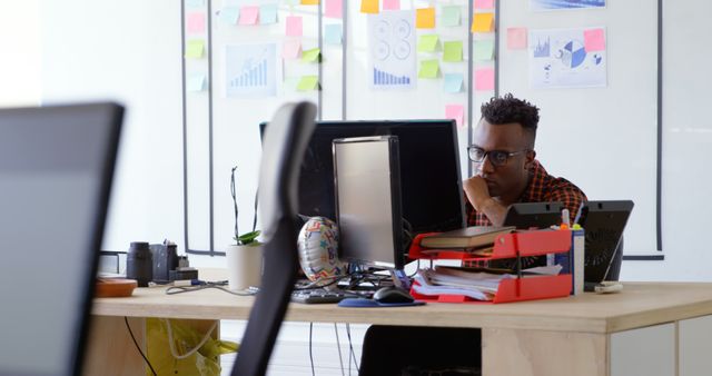 Man Deep in Thought While Working at Cluttered Office Desk - Download Free Stock Images Pikwizard.com