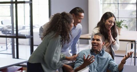 Diverse Colleagues Celebrating Achievement Together in Office