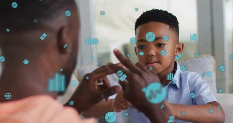 Father and Son Engaged in Interactive Digital Learning