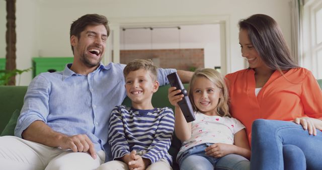 Happy Family Sitting Together on Couch Watching TV - Download Free Stock Images Pikwizard.com