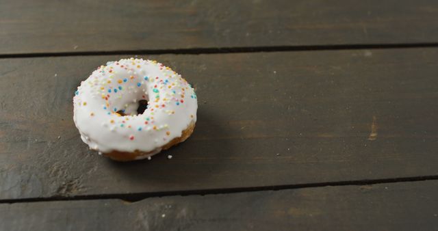 White Iced Donut with Sprinkles on Wooden Surface - Download Free Stock Images Pikwizard.com