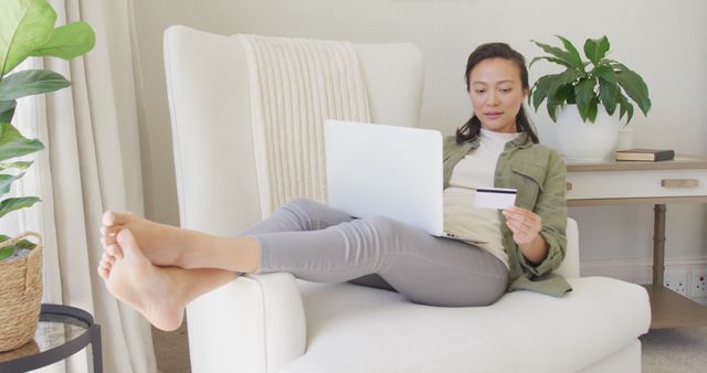 Woman Shopping Online with Laptop and Credit Card Relaxing on Chair - Download Free Stock Images Pikwizard.com