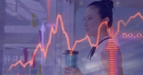 Asian Woman Analyzing Digital Financial Data in Office Setting