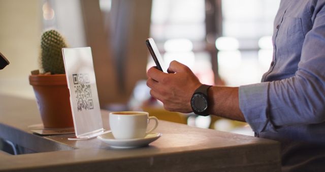 Man scanning QR code with smartphone in cafe - Download Free Stock Images Pikwizard.com