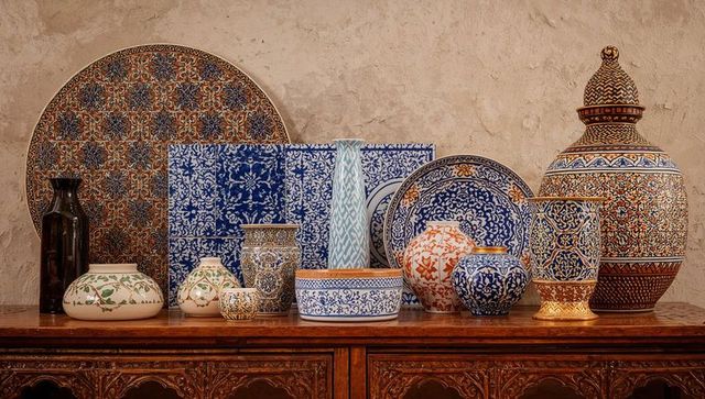 Displaying hand-painted mediterranean ceramics on carved wooden sideboard