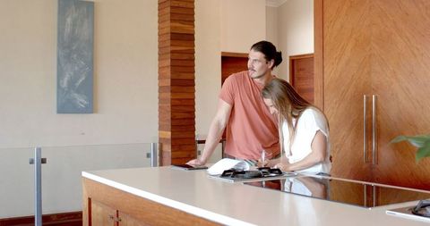 Couple discussing plans in modern kitchen setting