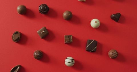 Assorted chocolates on red background symbolizing love