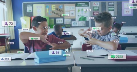 Boys making hand gestures while digital social media metrics float over classroom desks