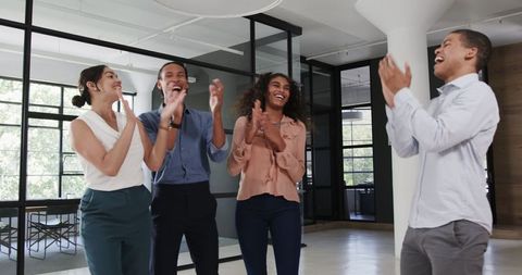 Diverse team celebrating success with smiles and applause