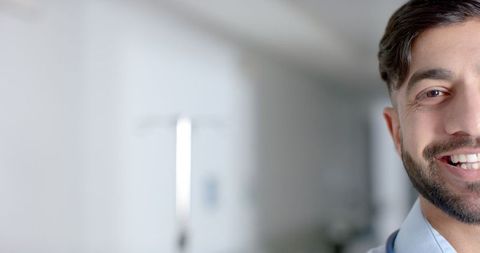 Smiling Young Doctor in Hospital Corridor with Copy Space