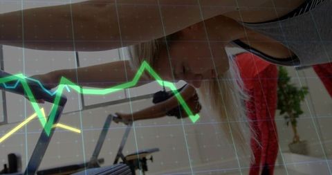 Indoor cycling class tracking performance with digital metrics overlay
