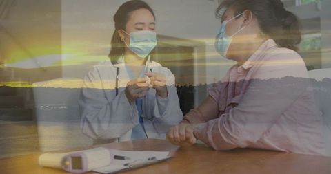 Nurse preparing syringe for masked patient with tranquil sunset seascape overlay